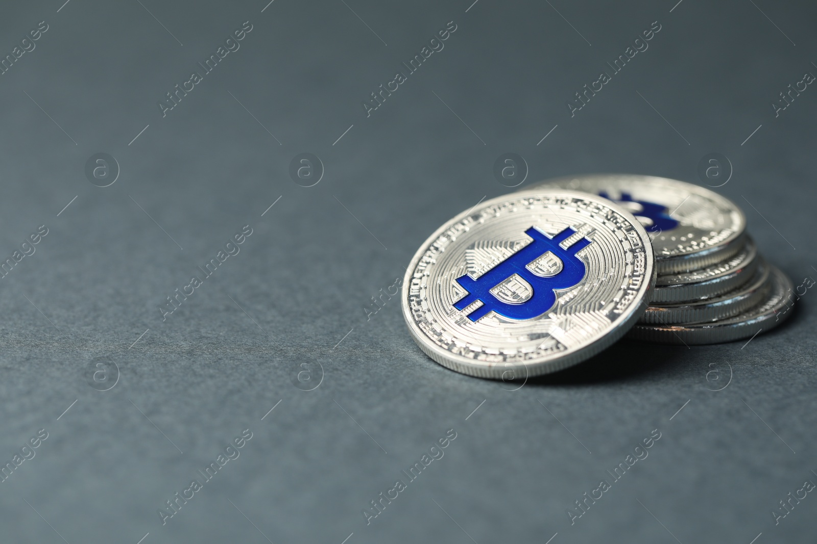 Cryptocurrency. Many bitcoins on grey background, closeup. Space for text Photo of Cryptocurrency. Many bitcoins on grey background, closeup. Space for text