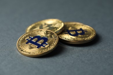 Photo of Cryptocurrency. Many bitcoins on grey background, closeup