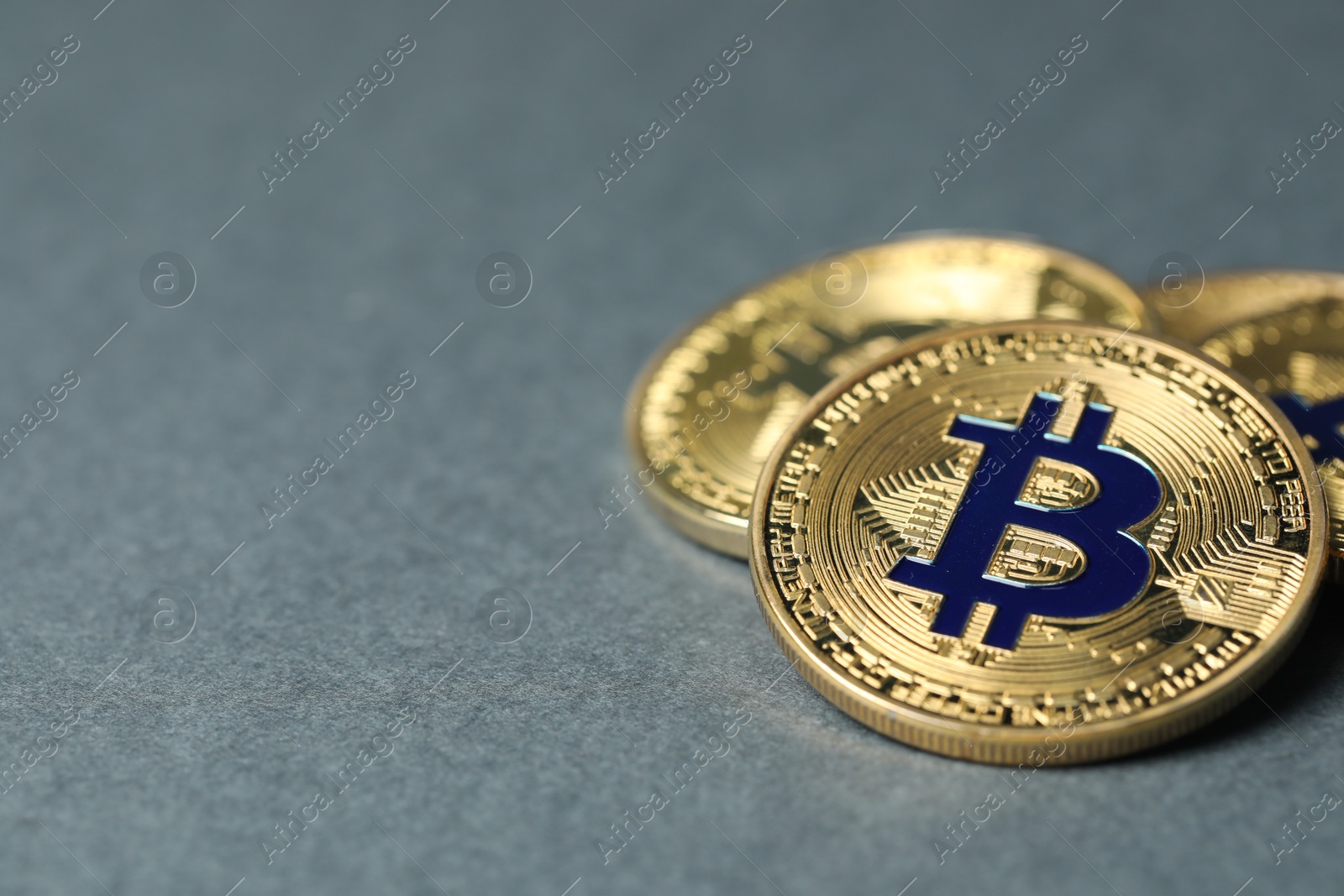 Cryptocurrency. Many bitcoins on grey background, closeup. Space for text Photo of Cryptocurrency. Many bitcoins on grey background, closeup. Space for text