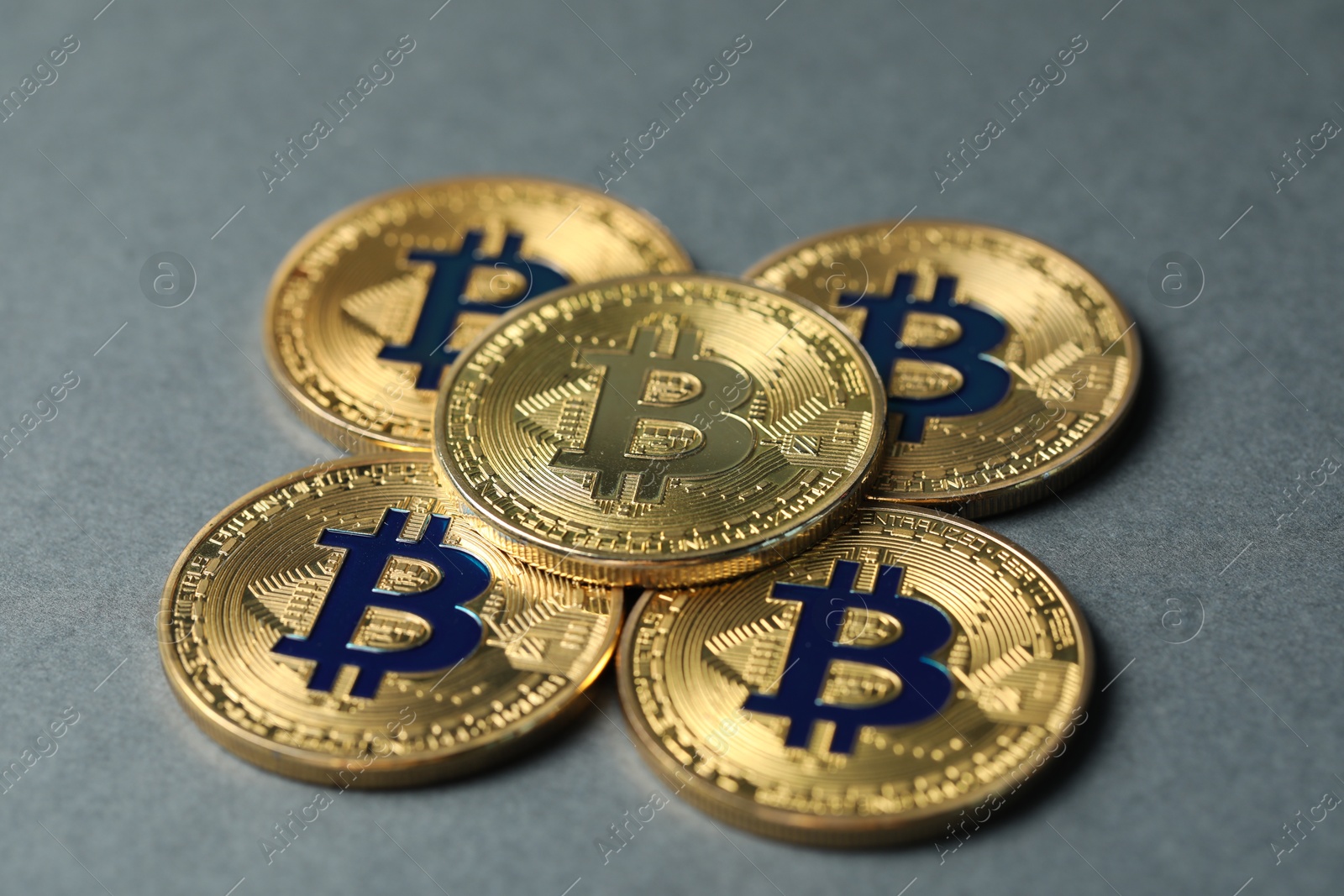 Cryptocurrency. Many bitcoins on grey background, closeup Photo of Cryptocurrency. Many bitcoins on grey background, closeup