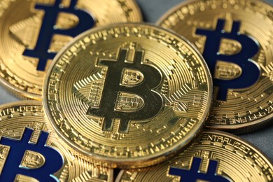 Photo of Cryptocurrency. Many bitcoins on grey background, closeup