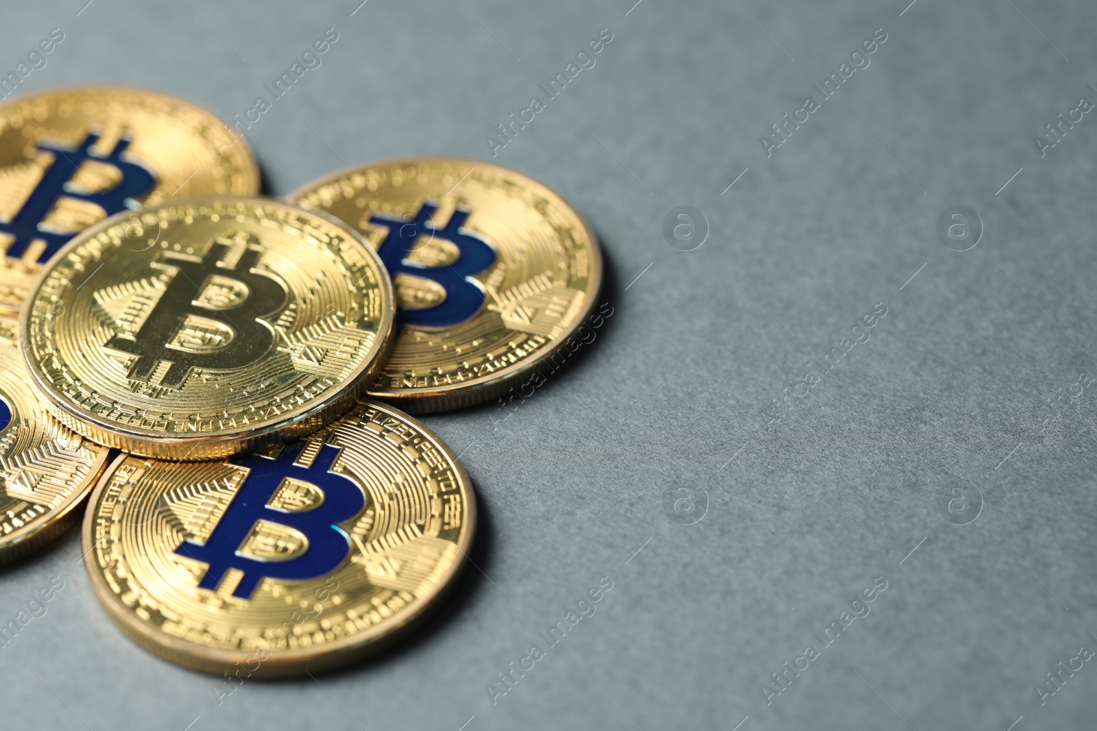 Cryptocurrency. Many bitcoins on grey background, closeup. Space for text Photo of Cryptocurrency. Many bitcoins on grey background, closeup. Space for text
