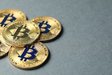 Photo of Cryptocurrency. Many bitcoins on grey background, closeup. Space for text