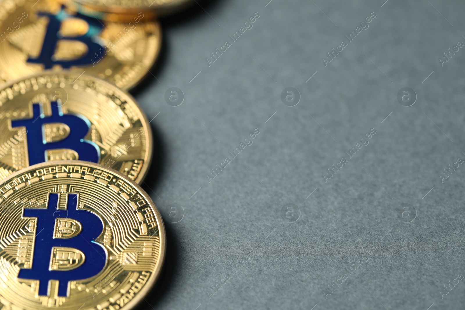 Cryptocurrency. Many bitcoins on grey background, closeup. Space for text Photo of Cryptocurrency. Many bitcoins on grey background, closeup. Space for text