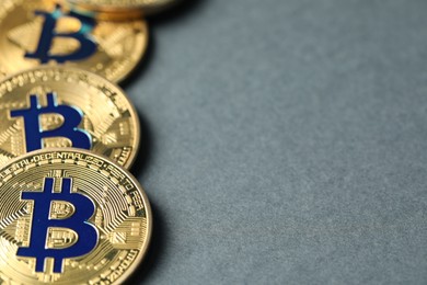 Photo of Cryptocurrency. Many bitcoins on grey background, closeup. Space for text