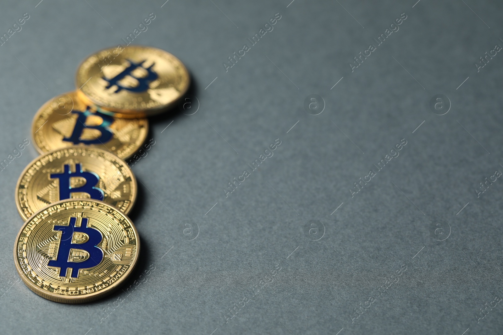 Cryptocurrency. Many bitcoins on grey background, closeup. Space for text Photo of Cryptocurrency. Many bitcoins on grey background, closeup. Space for text