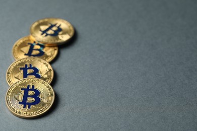 Photo of Cryptocurrency. Many bitcoins on grey background, closeup. Space for text