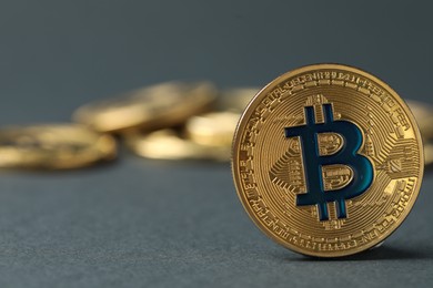 Photo of Cryptocurrency. Many bitcoins on grey background, closeup. Space for text