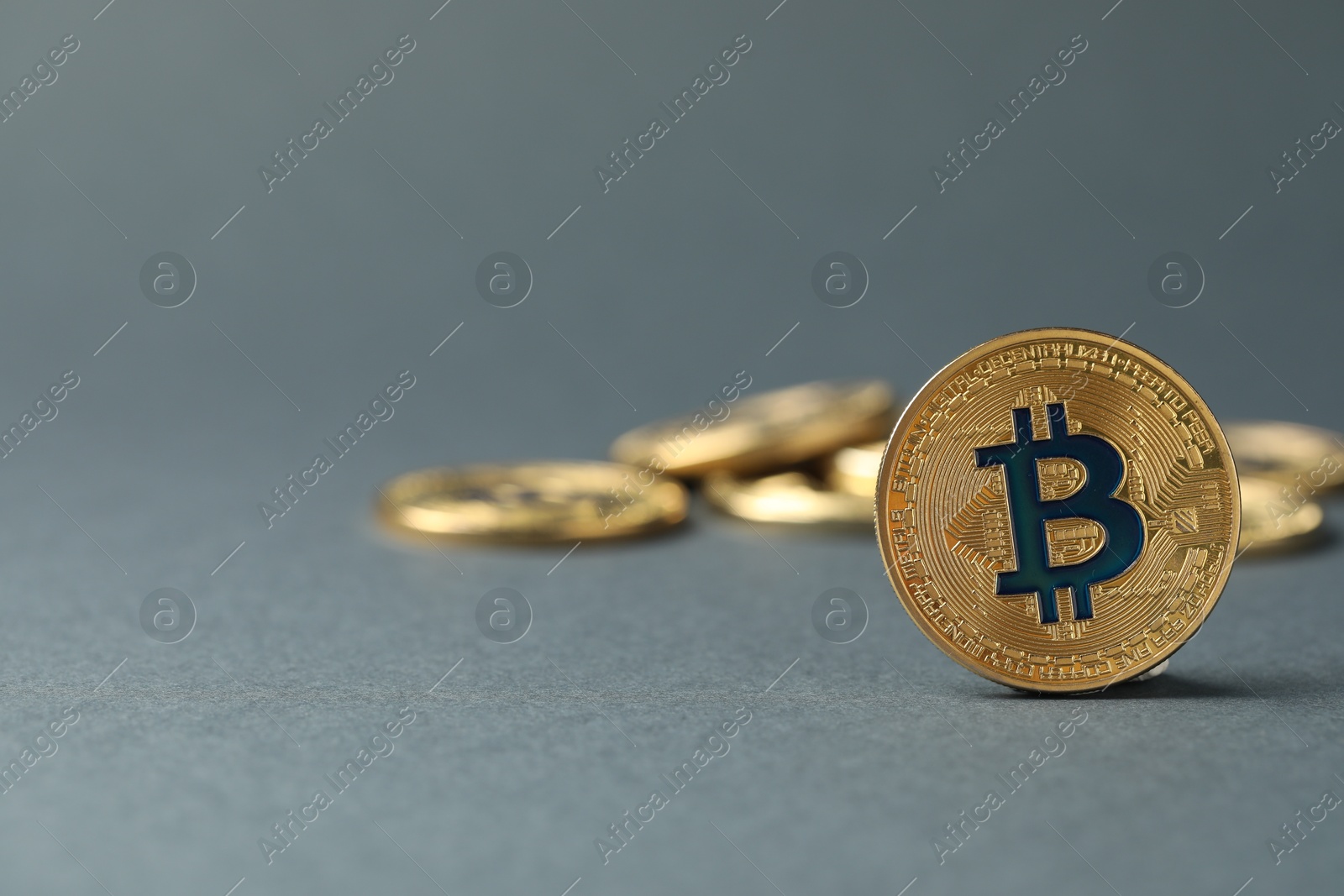 Cryptocurrency. Many bitcoins on grey background, closeup. Space for text Photo of Cryptocurrency. Many bitcoins on grey background, closeup. Space for text