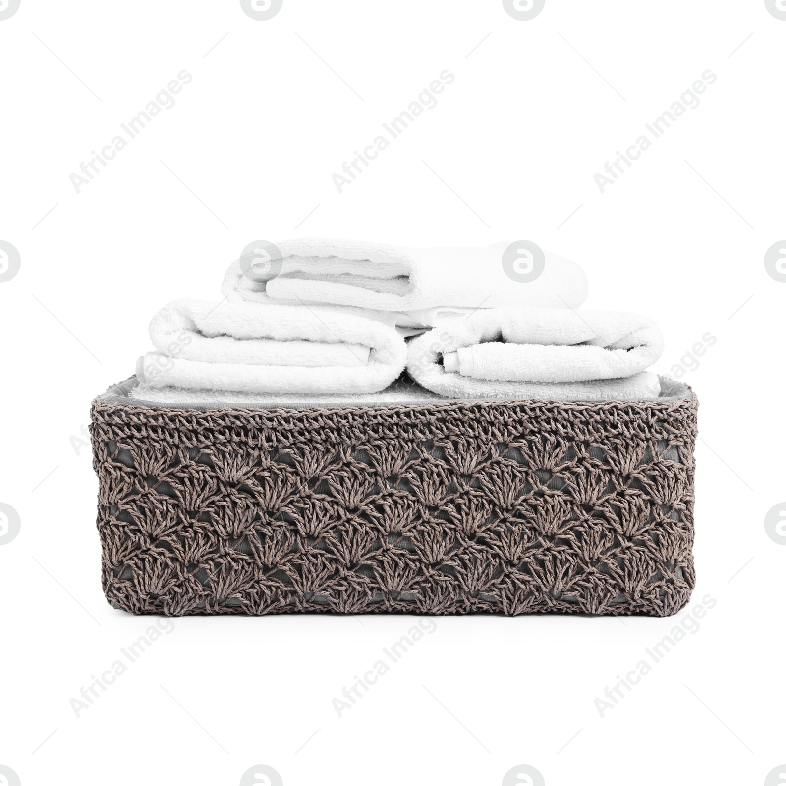 Clean towels in basket isolated on white Photo of Clean towels in basket isolated on white