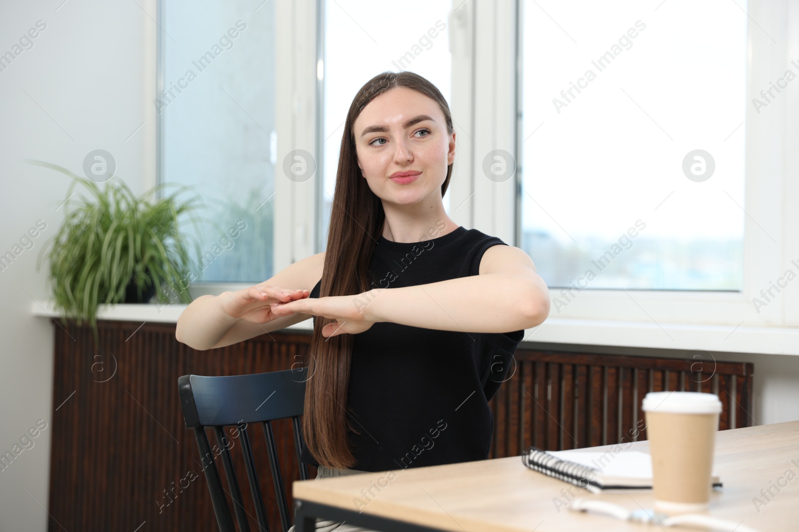Beautiful woman stretching on chair in office Photo of Beautiful woman stretching on chair in office