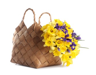 Photo of Bouquet of beautiful daffodils and irises in basket isolated on white