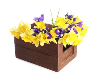 Photo of Bouquet of beautiful daffodils and irises in crate isolated on white