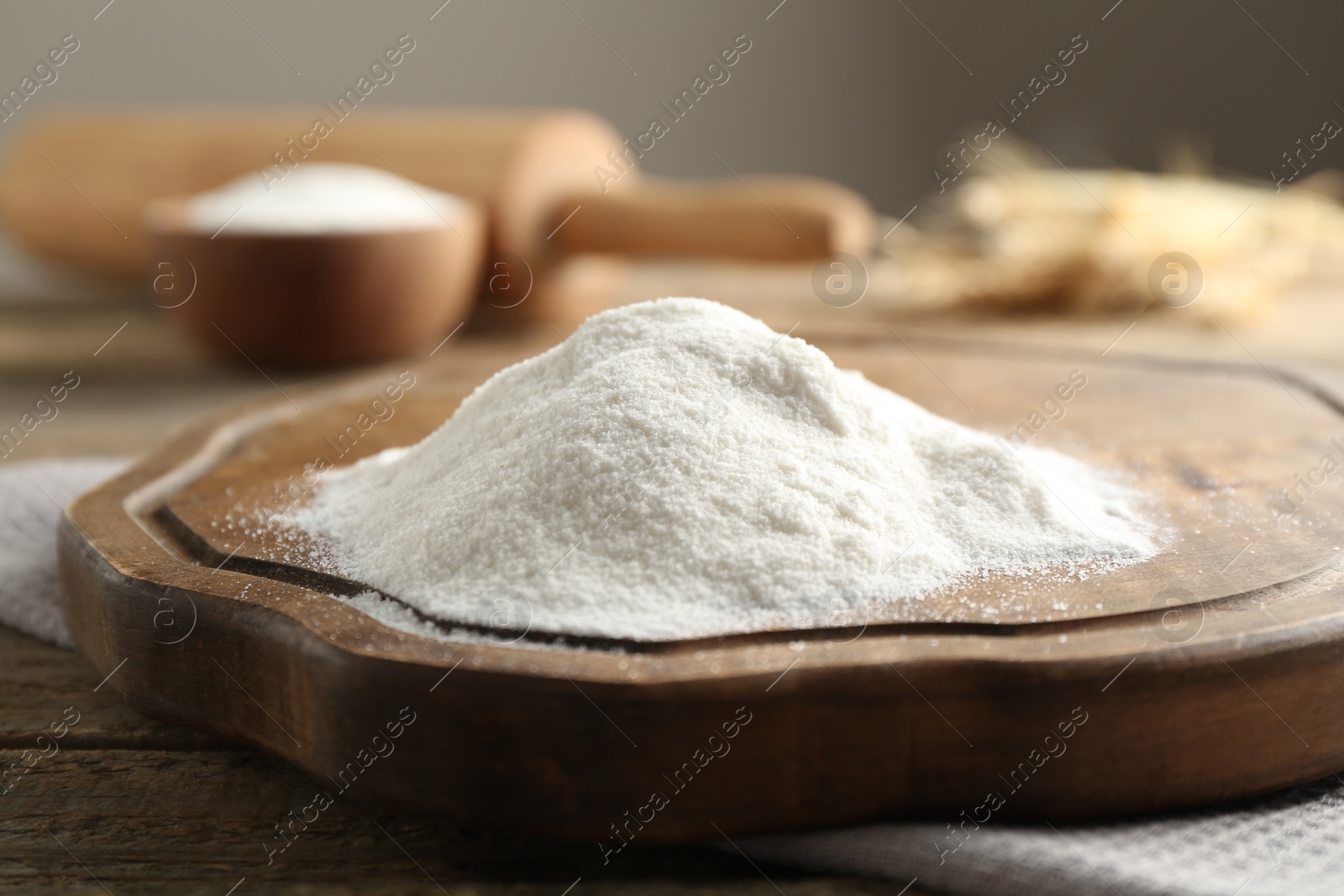 Pile of wheat flour on wooden table, closeup Photo of Pile of wheat flour on wooden table, closeup