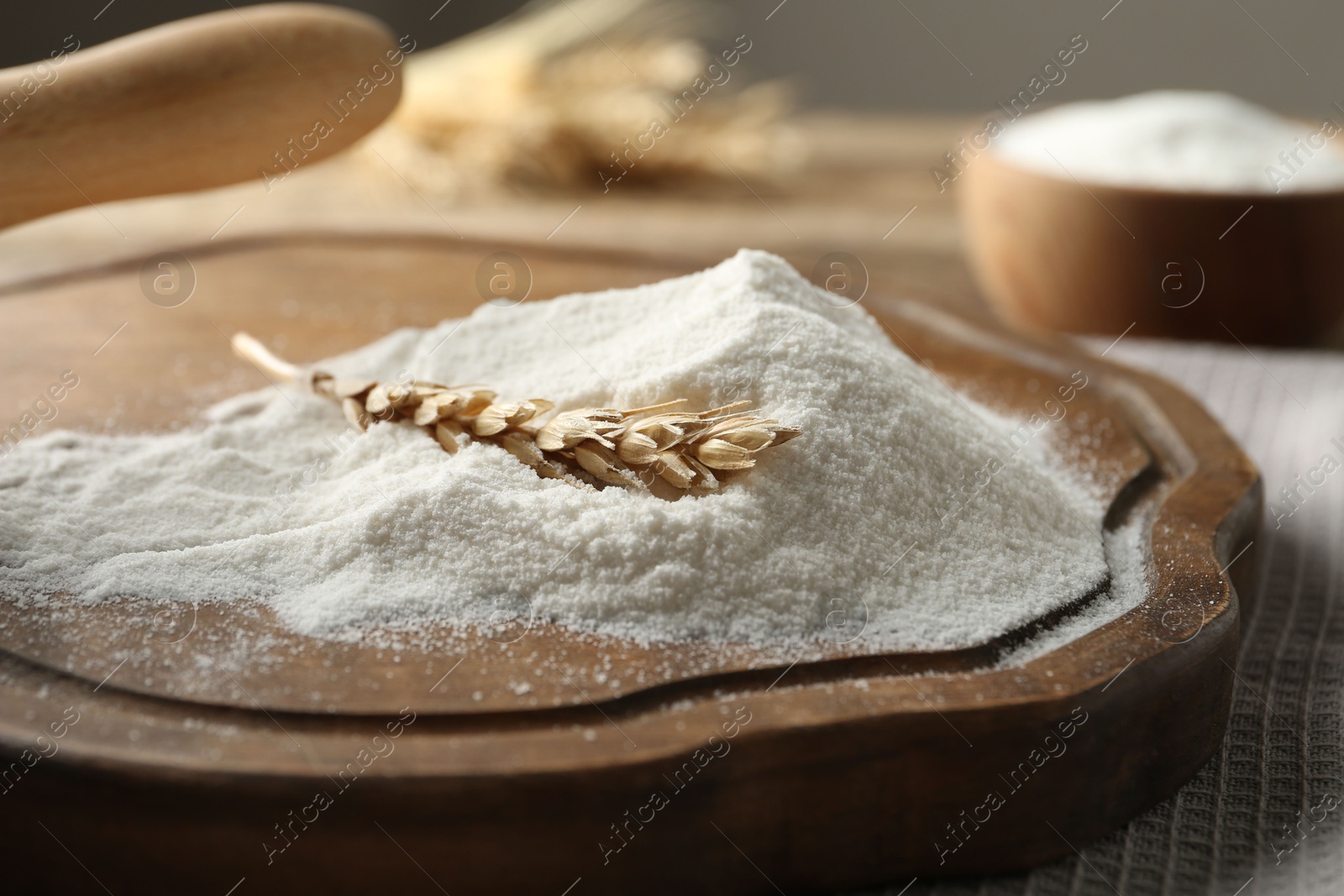 Wheat flour and spikelet on wooden table, closeup Photo of Wheat flour and spikelet on wooden table, closeup