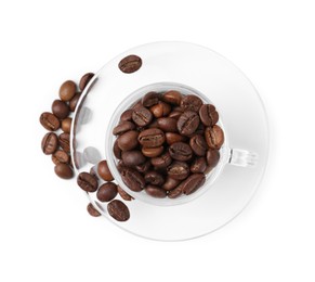 Photo of Aromatic coffee beans in cup and saucer isolated on white, top view
