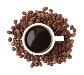 Photo of Aromatic coffee in cup and pile of beans isolated on white, top view