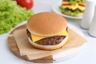 Photo of Cheeseburger with tasty patty on white table, closeup