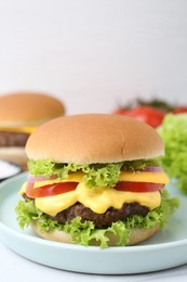 Photo of Tasty cheeseburger on white table, closeup. Space for text