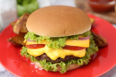 Photo of Tasty cheeseburger with lettuce and tomatoes on white table, closeup
