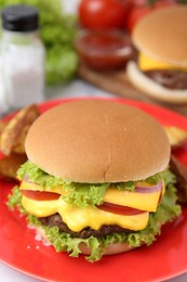 Photo of Tasty cheeseburger with lettuce and tomatoes on white table, closeup