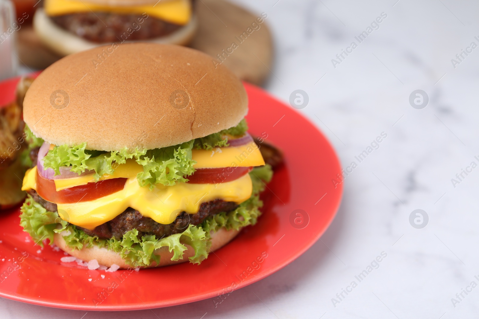 Tasty cheeseburger on white marble table, closeup. Space for text Photo of Tasty cheeseburger on white marble table, closeup. Space for text