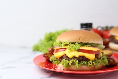 Photo of Tasty cheeseburger on white marble table, closeup. Space for text