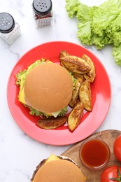 Photo of Tasty cheeseburger with potato wedges and ketchup on white marble table, flat lay