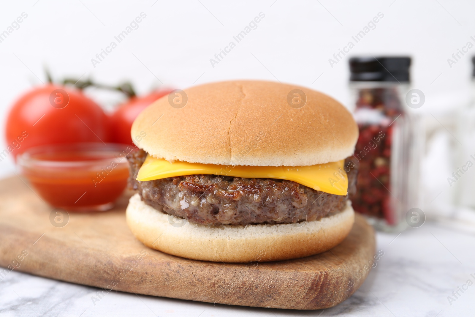 Tasty cheeseburger on white marble table, closeup Photo of Tasty cheeseburger on white marble table, closeup