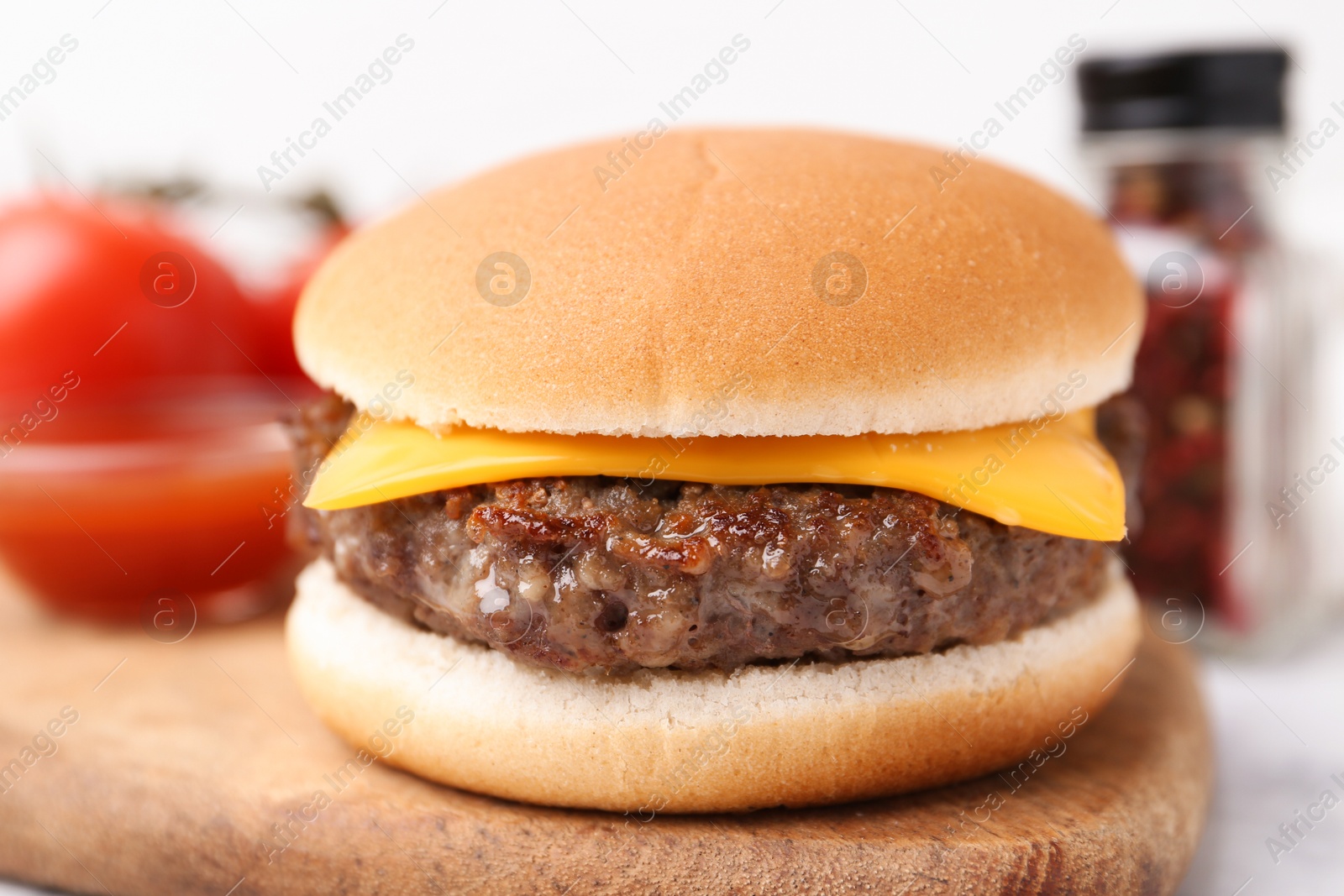 Cheeseburger with tasty patty on white table, closeup Photo of Cheeseburger with tasty patty on white table, closeup