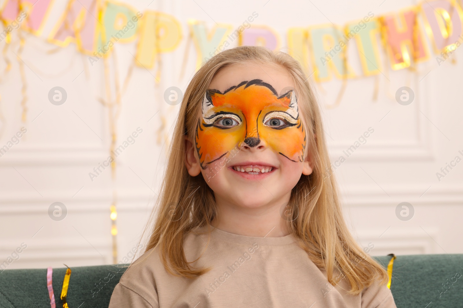 Cute girl with fox face painting indoors Photo of Cute girl with fox face painting indoors