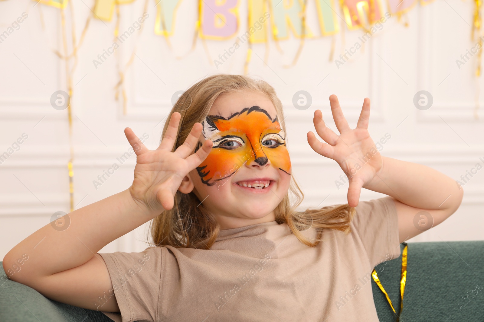 Cute girl with fox face painting indoors Photo of Cute girl with fox face painting indoors