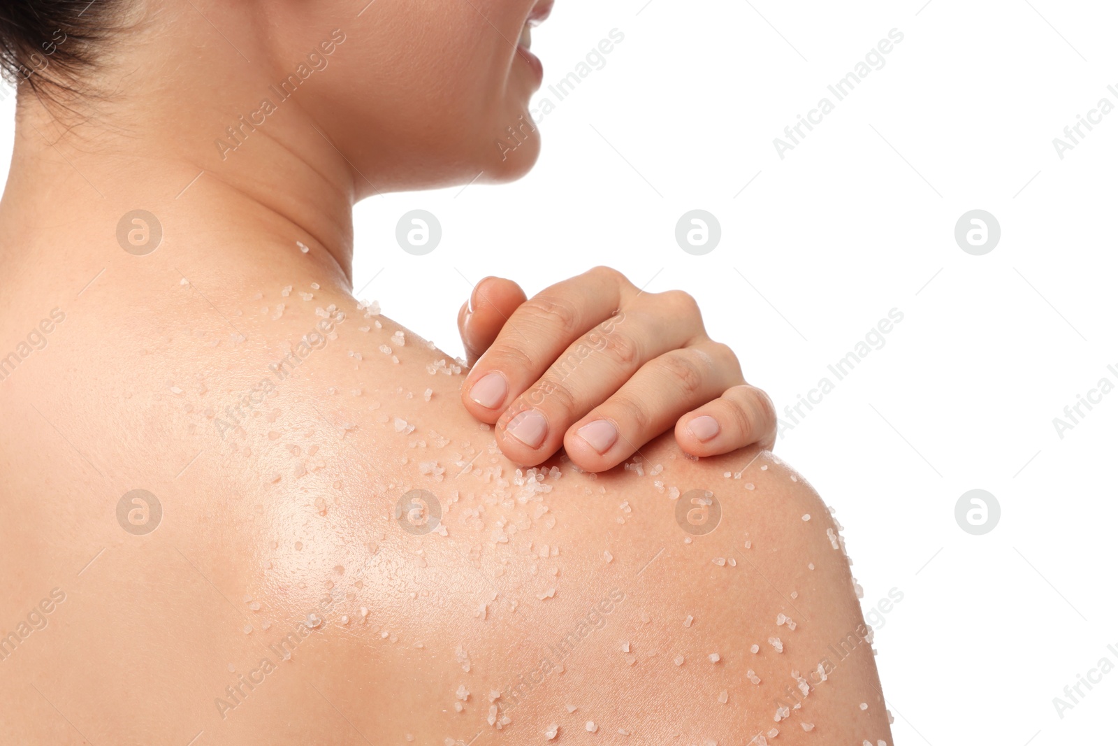 Woman applying body scrub onto her shoulder against white background, back view Photo of Woman applying body scrub onto her shoulder against white background, back view