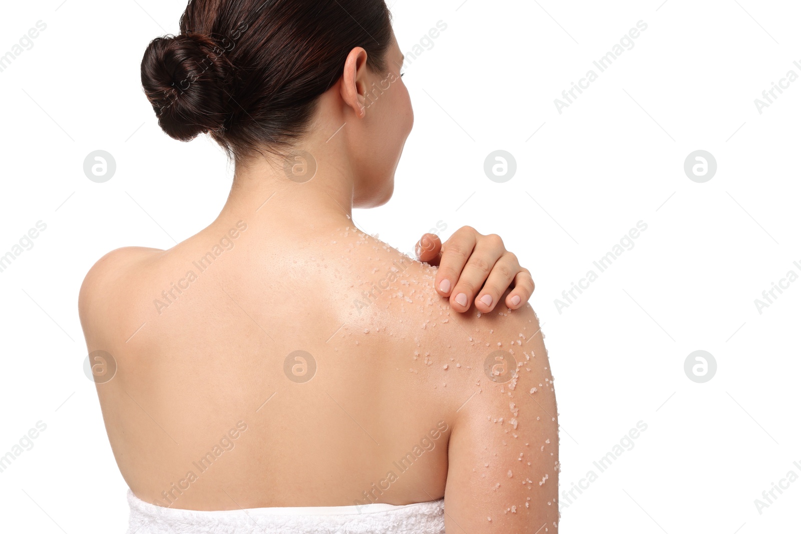 Woman applying body scrub onto her shoulder against white background, back view Photo of Woman applying body scrub onto her shoulder against white background, back view
