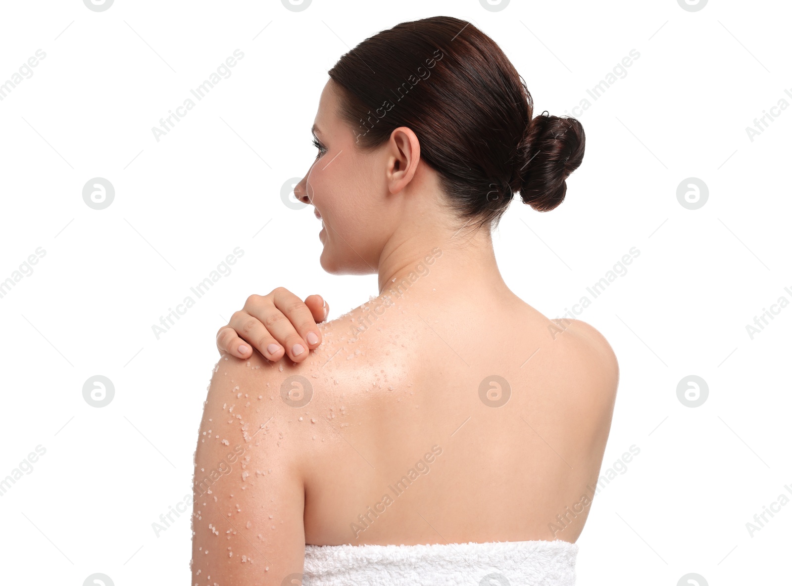 Woman applying body scrub onto her shoulder against white background Photo of Woman applying body scrub onto her shoulder against white background