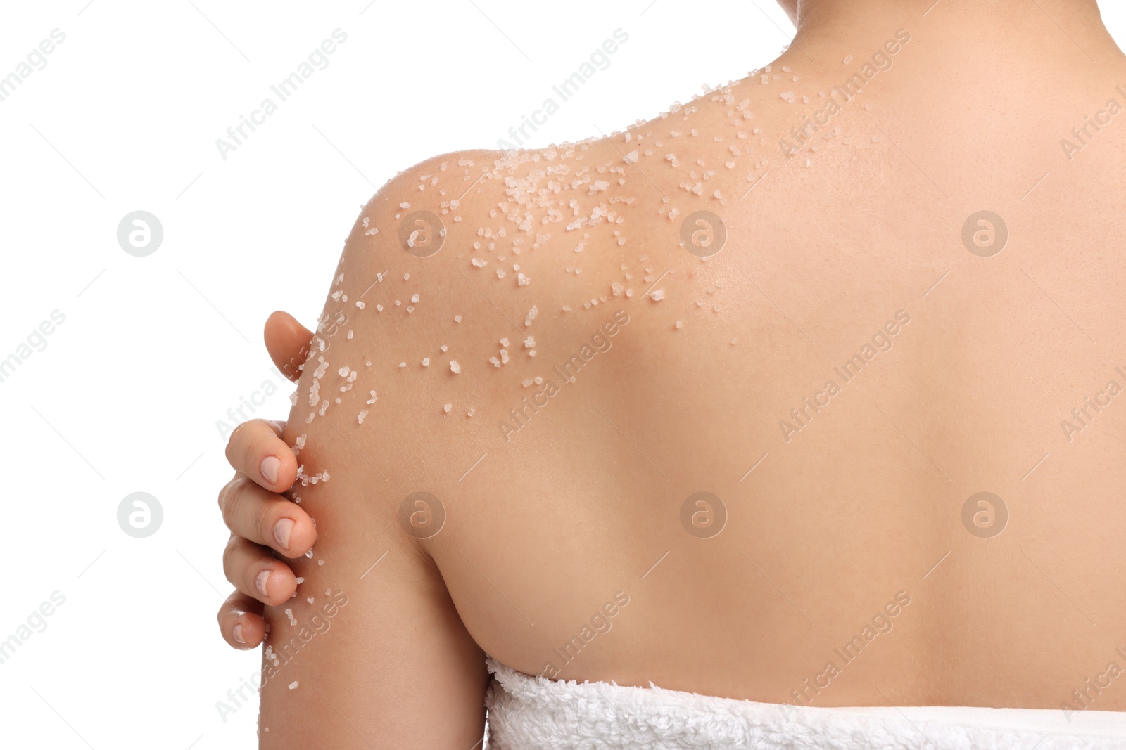 Woman applying body scrub onto her arm against white background, back view Photo of Woman applying body scrub onto her arm against white background, back view