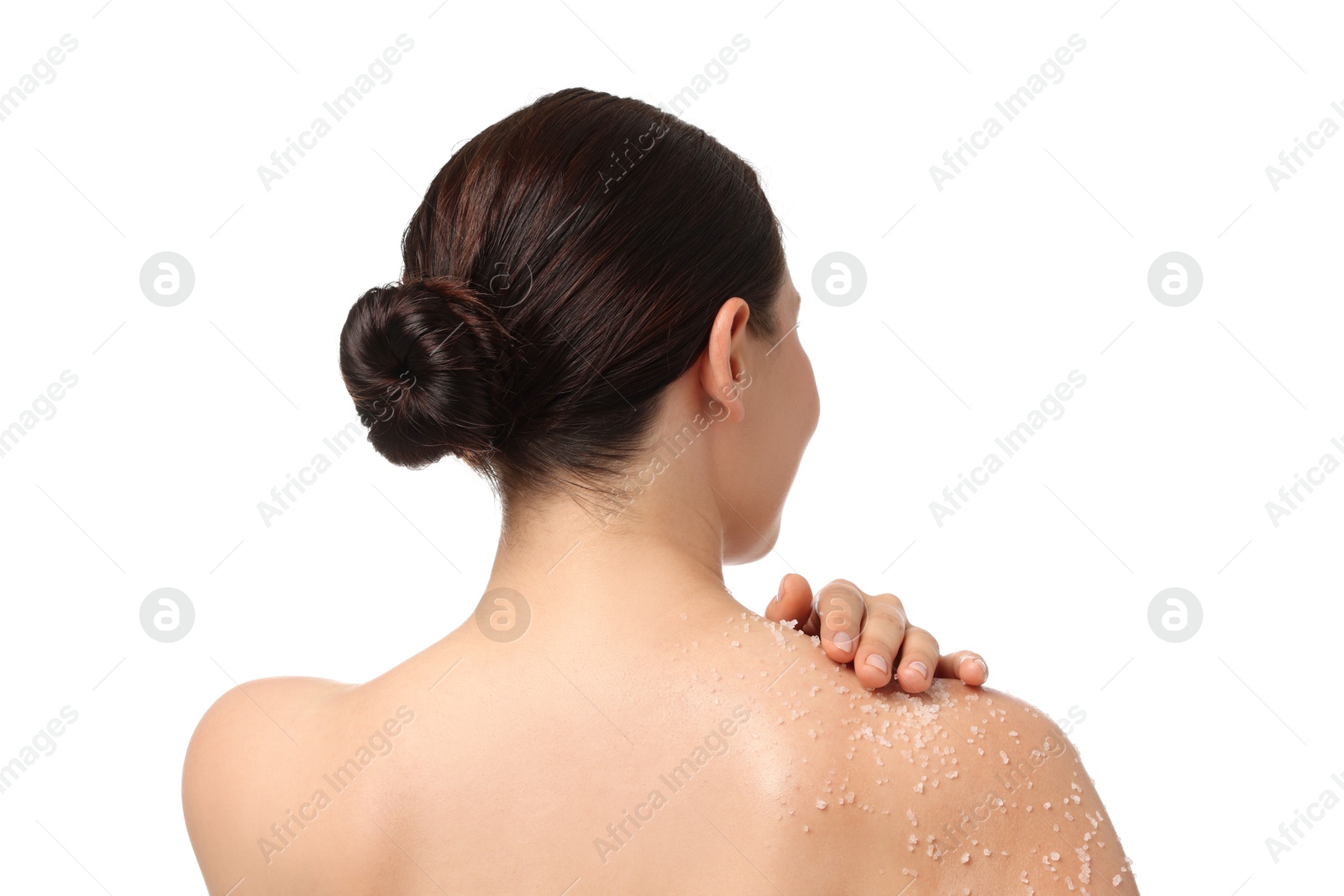Woman applying body scrub onto her shoulder against white background, back view Photo of Woman applying body scrub onto her shoulder against white background, back view