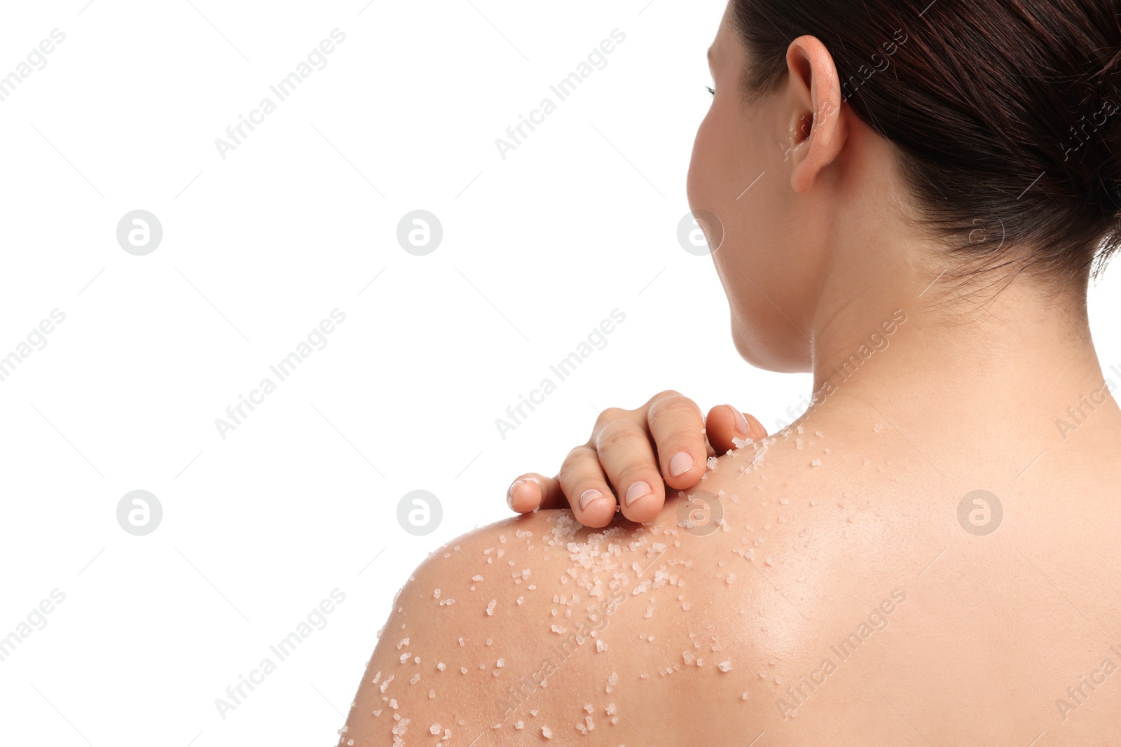 Woman applying body scrub onto her shoulder against white background, back view Photo of Woman applying body scrub onto her shoulder against white background, back view
