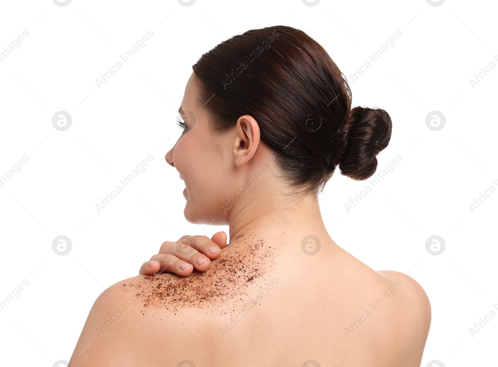 Woman applying body scrub onto her shoulder against white background Photo of Woman applying body scrub onto her shoulder against white background