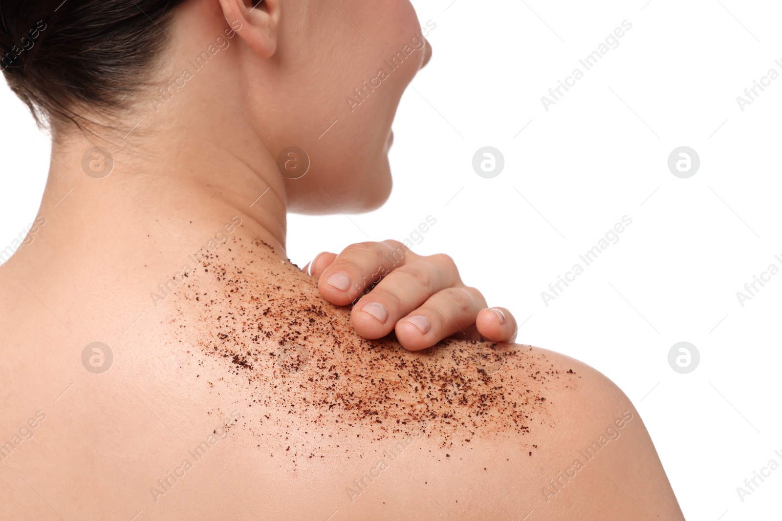 Woman applying body scrub onto her shoulder against white background, back view Photo of Woman applying body scrub onto her shoulder against white background, back view