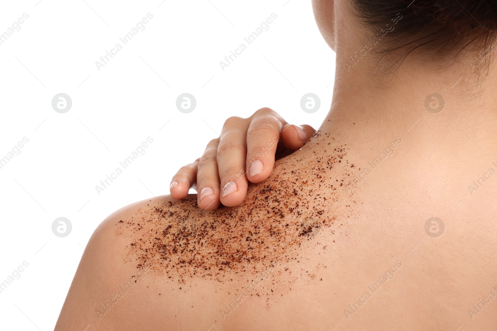 Woman applying body scrub onto her shoulder against white background, back view Photo of Woman applying body scrub onto her shoulder against white background, back view