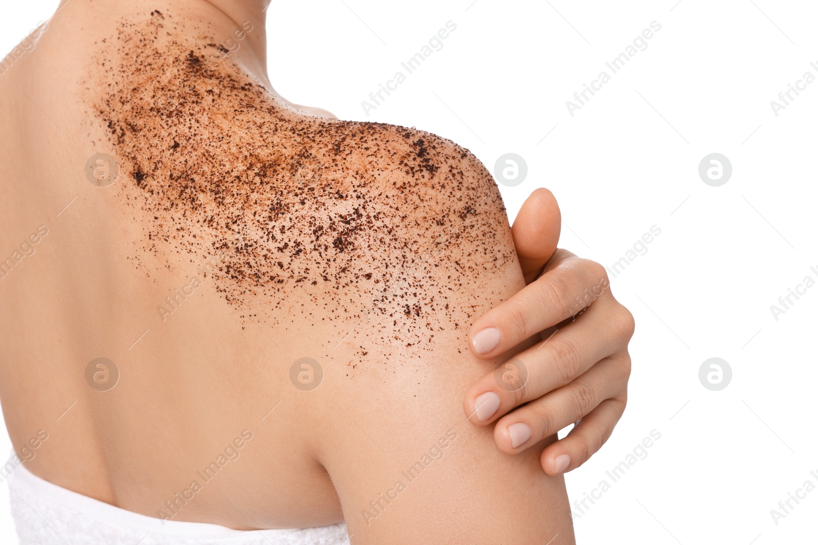 Woman applying body scrub onto her shoulder against white background, back view Photo of Woman applying body scrub onto her shoulder against white background, back view