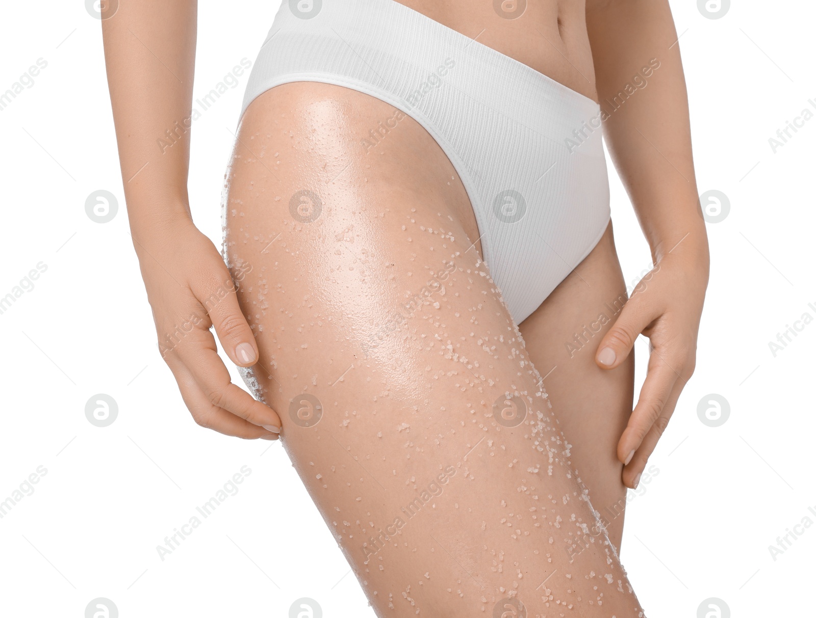 Woman with body scrub on her leg against white background, closeup Photo of Woman with body scrub on her leg against white background, closeup
