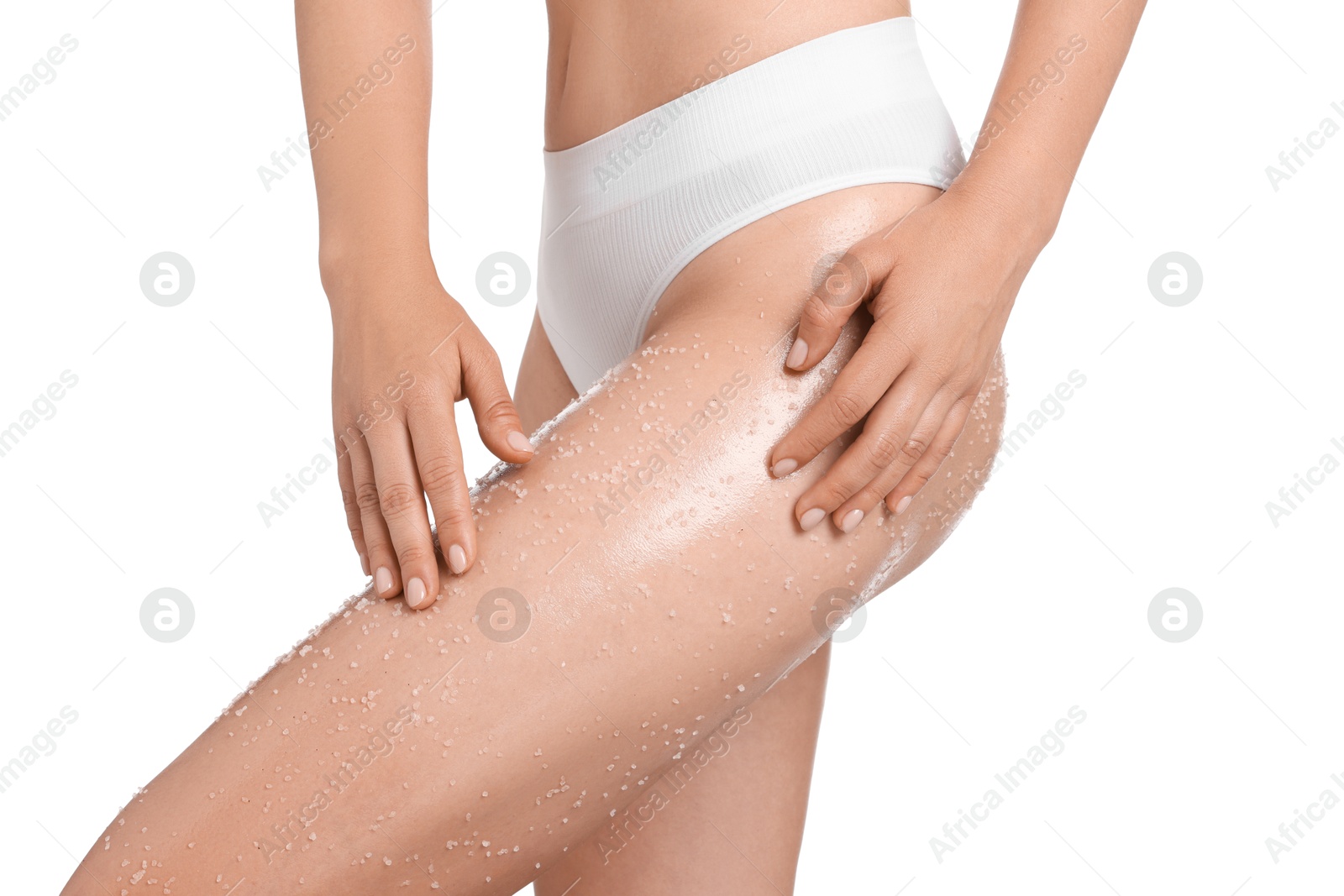 Woman with body scrub on her leg against white background, closeup Photo of Woman with body scrub on her leg against white background, closeup