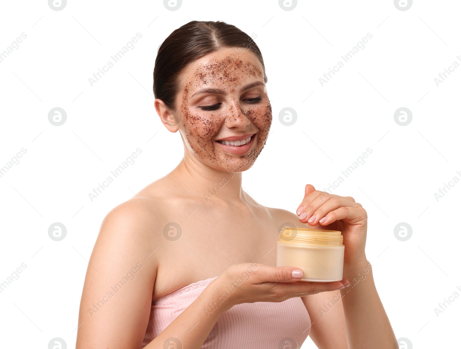 Smiling woman with body scrub on her face and jar against white background Photo of Smiling woman with body scrub on her face and jar against white background