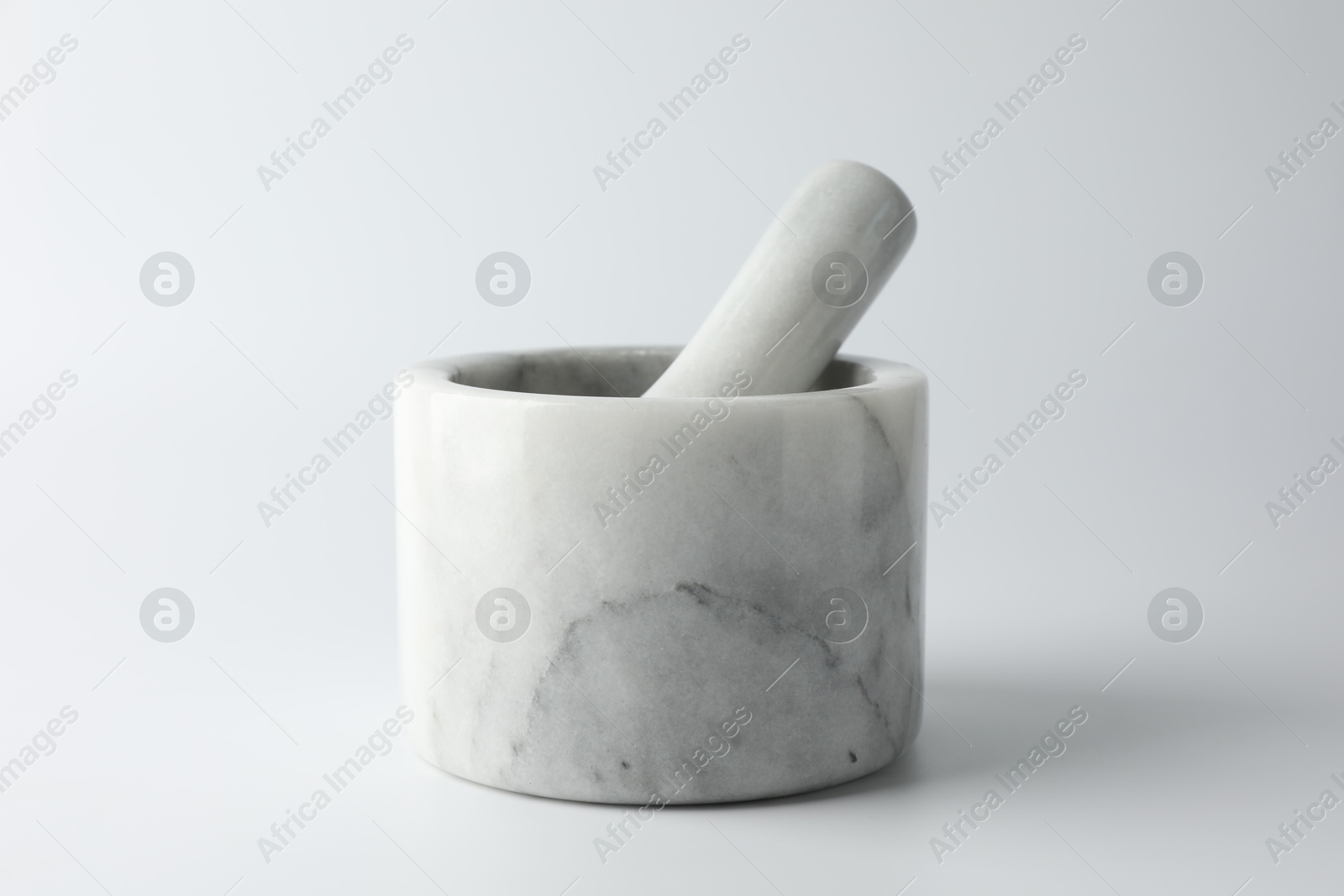 Marble mortar with pestle on white background, closeup Photo of Marble mortar with pestle on white background, closeup