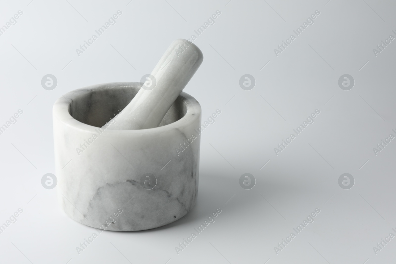 Marble mortar with pestle on white background, space for text Photo of Marble mortar with pestle on white background, space for text