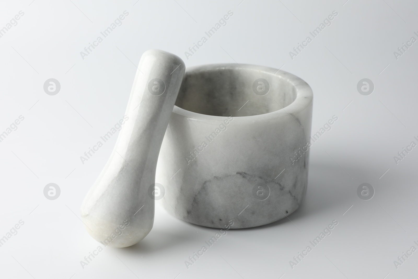 Marble mortar with pestle on white background, closeup Photo of Marble mortar with pestle on white background, closeup