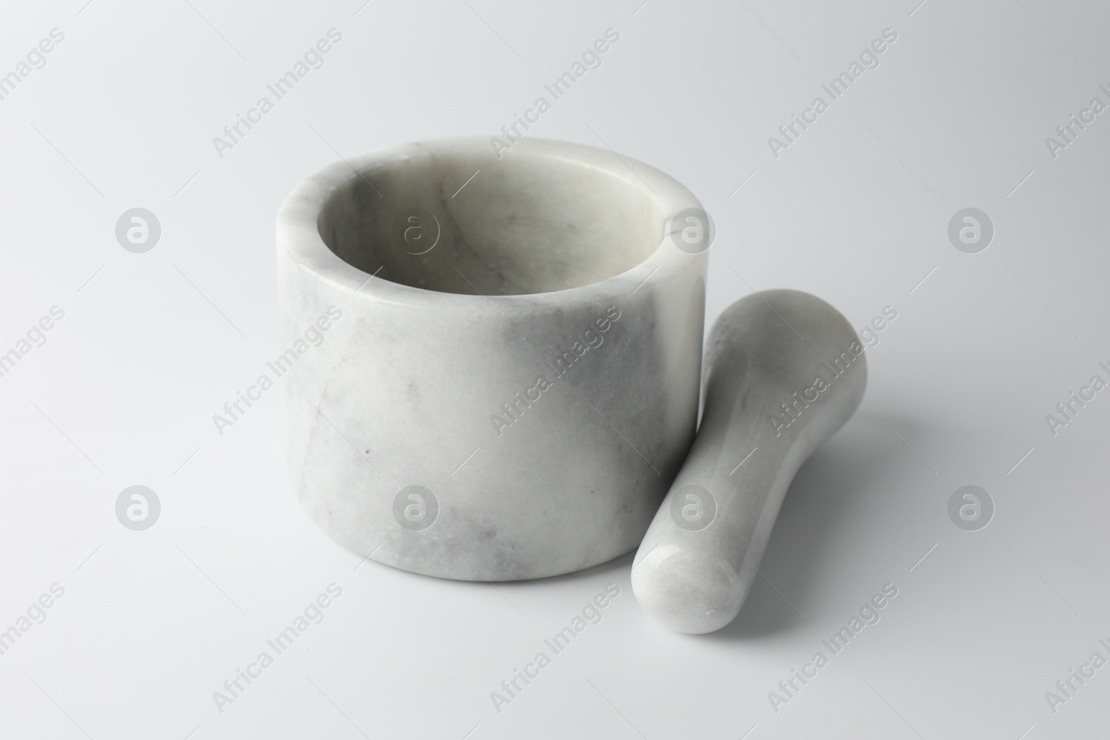 Marble mortar with pestle on white background, closeup Photo of Marble mortar with pestle on white background, closeup