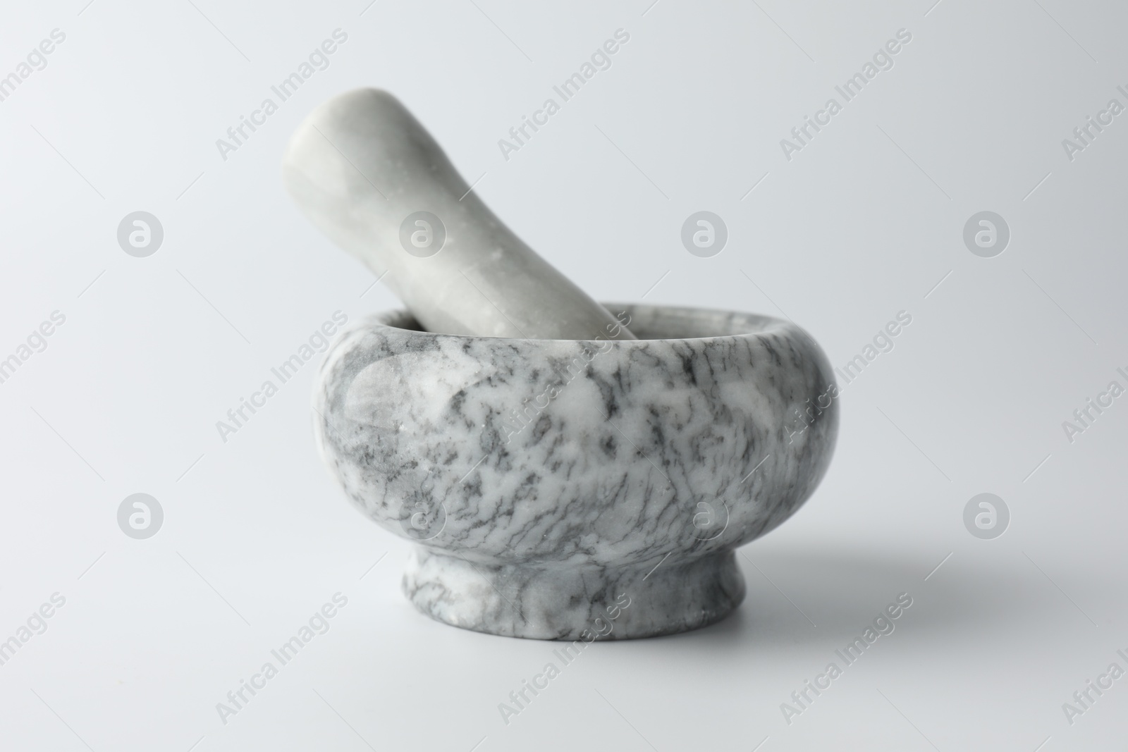 Marble mortar with pestle on white background Photo of Marble mortar with pestle on white background